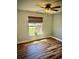 Bright bedroom features wood floors, ceiling fan, and natural light from the window at 13244 Doral Ave, Port Charlotte, FL 33953