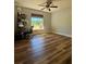 Bedroom with wood floors, ceiling fan, and a sunlit window at 13244 Doral Ave, Port Charlotte, FL 33953
