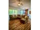 Spacious living room with a large sectional sofa, wood floors, and views into the dining area at 13244 Doral Ave, Port Charlotte, FL 33953