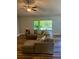 Comfortable living area with a large sectional sofa, wood-look floors, and a sliding glass door to the outdoors at 13244 Doral Ave, Port Charlotte, FL 33953