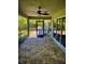 Covered brick patio featuring a ceiling fan with view of lush landscaping at 13244 Doral Ave, Port Charlotte, FL 33953