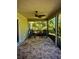 Screened patio with ceiling fan, brick floor and two rocking chairs at 13244 Doral Ave, Port Charlotte, FL 33953
