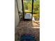 Inviting screened front porch with tiled flooring, potted plants, and a 'Welcome' mat at 13244 Doral Ave, Port Charlotte, FL 33953