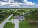 Spacious home featuring a circular driveway, attached two car garage, and landscaping in an open natural setting at 13252 Keystone Blvd, Port Charlotte, FL 33981