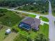 Aerial view shows the pool with screened enclosure in backyard of the home with surrounding greenery and neighborhood at 13252 Keystone Blvd, Port Charlotte, FL 33981