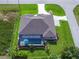 Aerial view showcases a screened-in pool, lush greenery, and well-maintained landscaping around the entire property at 13252 Keystone Blvd, Port Charlotte, FL 33981