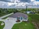 A beautiful single-story home displaying a two-car garage, circular driveway, and meticulously maintained lawn at 13252 Keystone Blvd, Port Charlotte, FL 33981