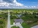 Spacious home featuring a circular driveway, attached two car garage, and landscaping in an open natural setting at 13252 Keystone Blvd, Port Charlotte, FL 33981