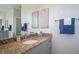 Bathroom with granite counters, grey cabinets, decorative mirror, and large sink basin at 13252 Keystone Blvd, Port Charlotte, FL 33981