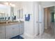 Bathroom featuring granite counters, blue accents, decorative mirror, and tile flooring at 13252 Keystone Blvd, Port Charlotte, FL 33981