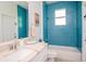 Stylish bathroom showcases blue tiled walls, vanity sink, and a modern, clean aesthetic at 13252 Keystone Blvd, Port Charlotte, FL 33981