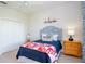 Cozy bedroom with a navy blue comforter, white walls, and a plush carpet providing warmth and comfort at 13252 Keystone Blvd, Port Charlotte, FL 33981
