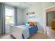 Comfortable bedroom featuring a plush blue comforter, white trim, and modern coastal accents at 13252 Keystone Blvd, Port Charlotte, FL 33981