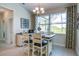 Dining area featuring a stylish table set, a modern chandelier, and large windows offering plenty of natural light at 13252 Keystone Blvd, Port Charlotte, FL 33981