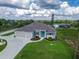 Stunning exterior with a three-car garage, well-maintained landscaping, and a pop of color from the front door at 13252 Keystone Blvd, Port Charlotte, FL 33981
