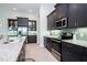 Modern kitchen featuring dark cabinets, stainless steel appliances, and granite countertops at 13252 Keystone Blvd, Port Charlotte, FL 33981