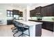Modern kitchen with dark cabinets, granite countertops, stainless steel appliances and bar stool seating at 13252 Keystone Blvd, Port Charlotte, FL 33981