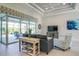 Bright and airy living room with neutral tones, offering a view of the pool area through sliding glass doors at 13252 Keystone Blvd, Port Charlotte, FL 33981