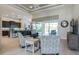 Inviting living room with pool views, stylish furniture, and an open layout connecting to the kitchen at 13252 Keystone Blvd, Port Charlotte, FL 33981