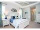 Bright main bedroom featuring a white bed frame, tray ceiling, and tasteful coastal-inspired decor at 13252 Keystone Blvd, Port Charlotte, FL 33981