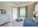 Relaxing main bedroom with view to pool area, decorated with coastal decor and plenty of natural light at 13252 Keystone Blvd, Port Charlotte, FL 33981