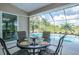 Covered patio with a dining set offering serene views of the pool and picturesque surroundings at 13252 Keystone Blvd, Port Charlotte, FL 33981