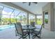 Covered patio with a dining set, overlooking the pool and a lush green landscape at 13252 Keystone Blvd, Port Charlotte, FL 33981