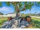 Charming backyard with a mature tree centerpiece and a built-in wooden planter at 13443 Boabadilla Ln, Port Charlotte, FL 33981