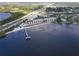 Aerial view showcases the property's beachfront location with a pool and dock close to the roadway at 14459 River Beach Dr # 122, Port Charlotte, FL 33953