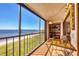 Relaxing balcony with seating and views of the beach and pier extending into the water at 14459 River Beach Dr # 122, Port Charlotte, FL 33953