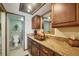 Bathroom featuring a stylish vanity with granite countertop, a vessel sink, and dark wooden cabinetry at 14459 River Beach Dr # 122, Port Charlotte, FL 33953