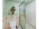 Neutral bathroom, a glass shower door, and a well-maintained toilet, exuding calm at 14459 River Beach Dr # 122, Port Charlotte, FL 33953