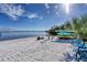 Expansive sandy beach with sun loungers and kayaks for an ideal seaside experience at 14459 River Beach Dr # 122, Port Charlotte, FL 33953