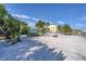 Sandy beach features multiple kayaks on storage racks with blue skies overhead at 14459 River Beach Dr # 122, Port Charlotte, FL 33953