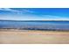 Expansive ocean view from the beautiful sandy beach with light cloud cover on a sunny day at 14459 River Beach Dr # 122, Port Charlotte, FL 33953
