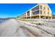 Beautiful beachfront condo with private access to the sandy beach and panoramic water views on a sunny day at 14459 River Beach Dr # 122, Port Charlotte, FL 33953