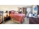 Relaxing bedroom with a decorative bed, balcony access, and tropical accents at 14459 River Beach Dr # 122, Port Charlotte, FL 33953