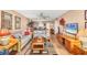 The living room is well-lit with comfortable wicker furniture and a view into the dining room at 14459 River Beach Dr # 122, Port Charlotte, FL 33953