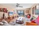 The living room features wicker furniture, tile floors, and a sliding glass door to a balcony at 14459 River Beach Dr # 122, Port Charlotte, FL 33953