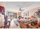 The living room boasts comfortable seating, tile floors, and a sliding glass door to the outside at 14459 River Beach Dr # 122, Port Charlotte, FL 33953