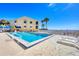Inviting pool area with lounge chairs, palm trees, and community amenities, perfect for outdoor relaxation at 14459 River Beach Dr # 122, Port Charlotte, FL 33953