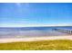 Scenic water view featuring a sandy beach and pier extending into the calm water at 14459 River Beach Dr # 122, Port Charlotte, FL 33953