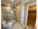 Bathroom featuring marble floors, toilet, and glass shower door to walk-in closet at 1490 Janet Pl, Englewood, FL 34223