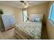 Bedroom featuring bed, dresser, and large window with natural light at 1490 Janet Pl, Englewood, FL 34223