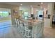Kitchen island with marble countertops and seating for four provides a casual dining and gathering space at 1490 Janet Pl, Englewood, FL 34223