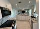 Modern kitchen featuring granite countertops and stainless steel appliances offers seamless flow to the living room at 1490 Janet Pl, Englewood, FL 34223