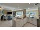 Open-concept kitchen with marble countertops, stainless steel appliances, and a seamless flow to the living area at 1490 Janet Pl, Englewood, FL 34223
