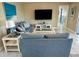 Inviting living room featuring stylish decor, tile flooring and entertainment setup at 1490 Janet Pl, Englewood, FL 34223
