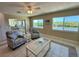 Cozy living room with water views, tile flooring, and comfortable seating at 1490 Janet Pl, Englewood, FL 34223