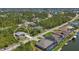 Aerial view of a single-Gathering home in a wooded area with canals and other houses nearby at 15613 Alsask Cir, Port Charlotte, FL 33981